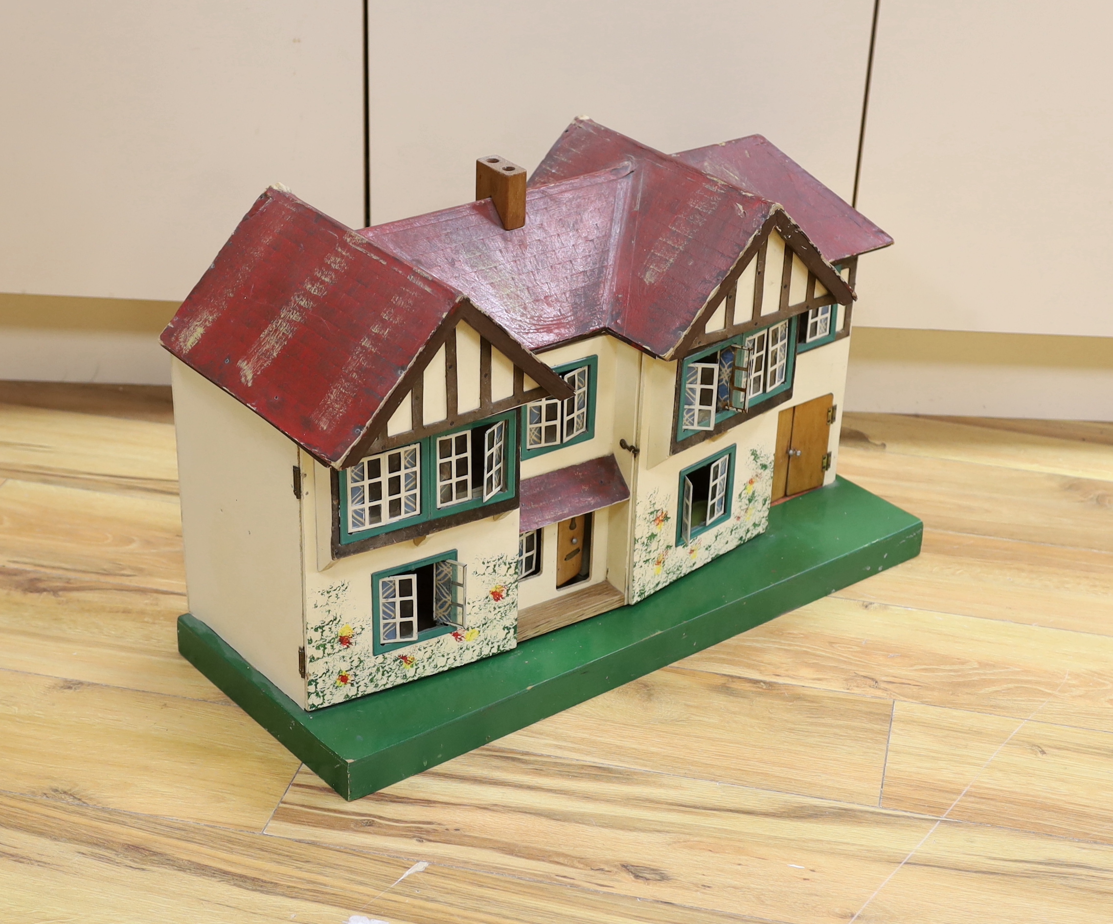 A 1930's Tri-ang doll's house with opening front and a small quantity of furniture